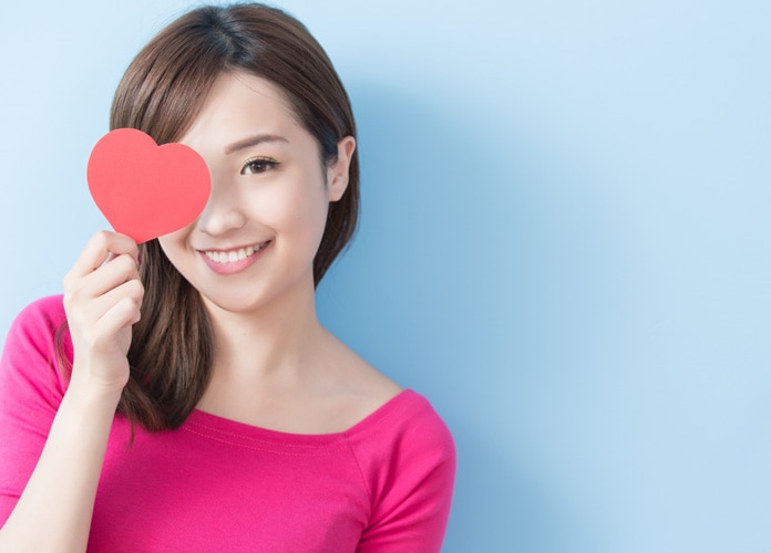 asian woman with pink heart